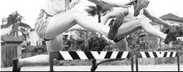 photo of women jumping hurdles